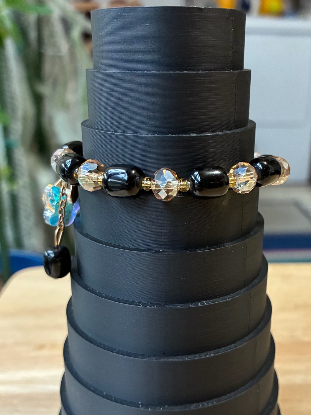 Black and Gold Beaded Stretch Bracelet with Iridescent Flower Charm - Picture 2 of 9
